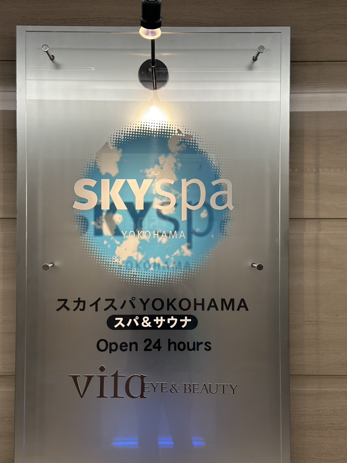 スカイスパYOKOHAMAの名前と館内施設の案内が掲示された入口